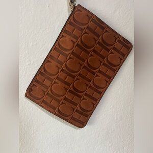 CarolinaHerrera Wristlet with CH Logo
Color- congac/brown
Approximate size 6”x9”